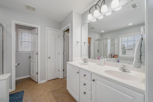 bathroom with tile patterned flooring, an enclosed shower, and vanity