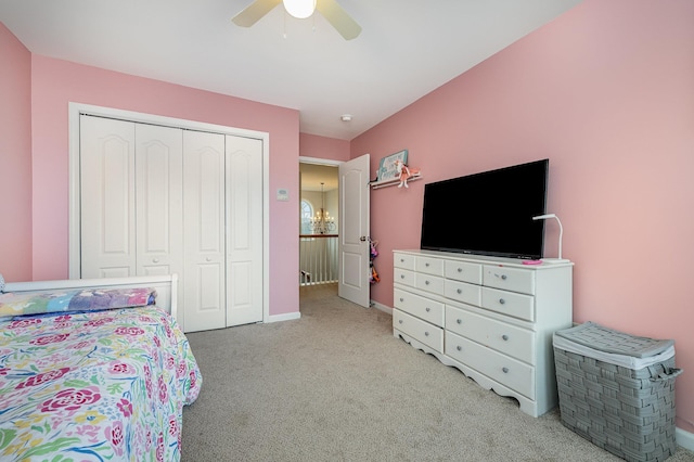 carpeted bedroom with a closet and ceiling fan