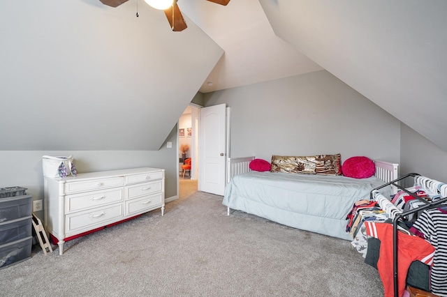 carpeted bedroom with ceiling fan and vaulted ceiling