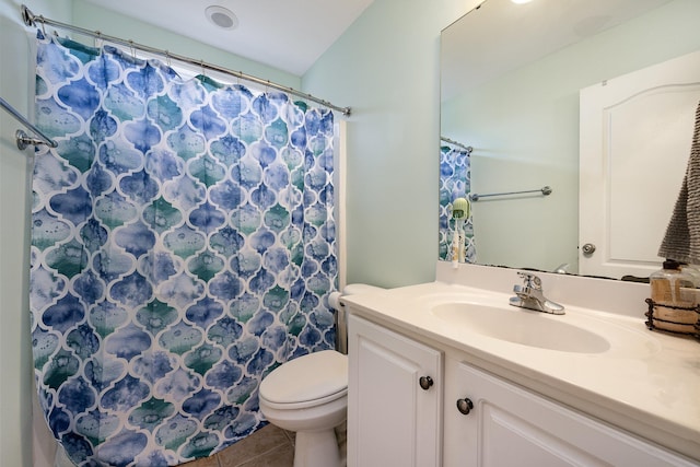 bathroom featuring vanity, tile patterned flooring, and toilet