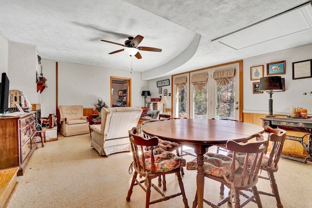 dining room with ceiling fan and a textured ceiling