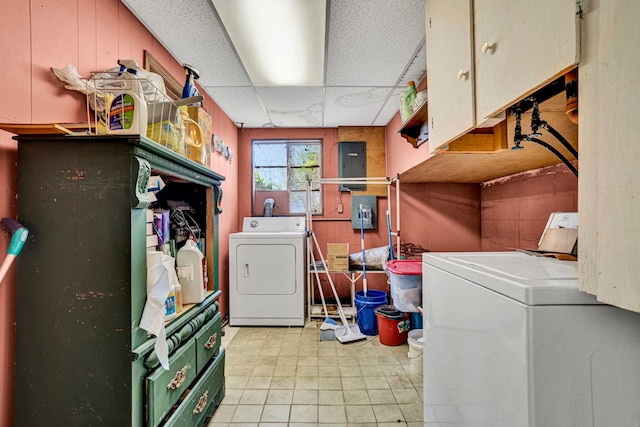 laundry area featuring washing machine and clothes dryer and cabinets