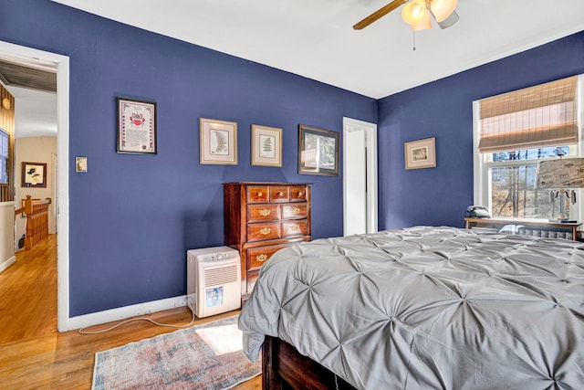 bedroom with ceiling fan and light hardwood / wood-style floors