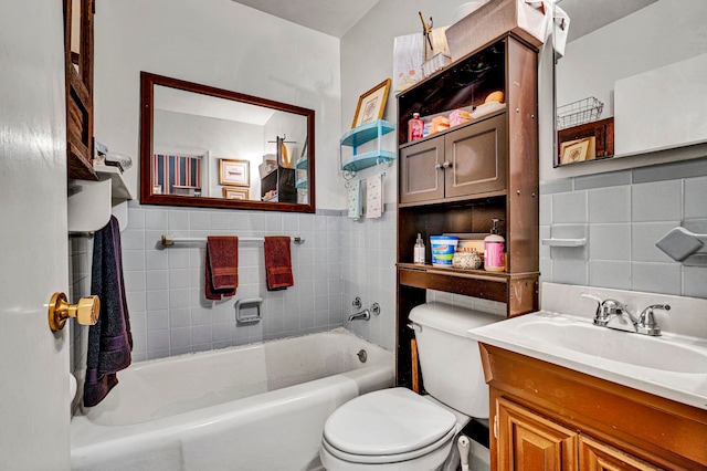 bathroom featuring vanity, tile walls, and toilet