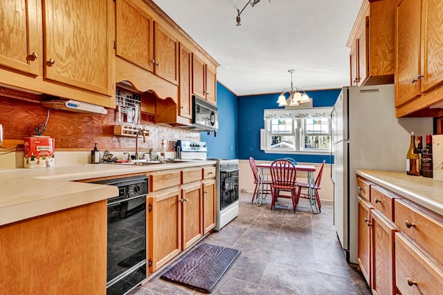 kitchen featuring sink, a notable chandelier, pendant lighting, black appliances, and decorative backsplash