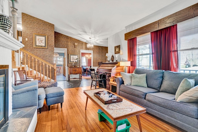 living room featuring hardwood / wood-style flooring, a notable chandelier, and a wealth of natural light