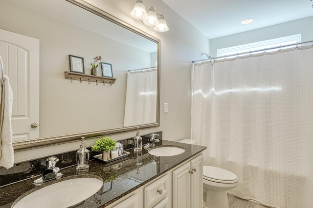 full bathroom with toilet, vanity, and shower / bathtub combination with curtain