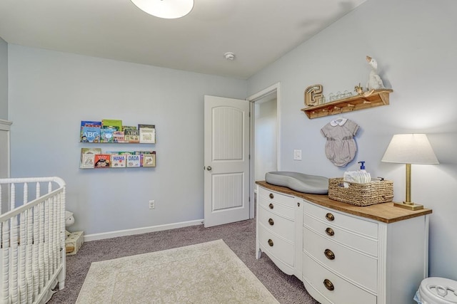 bedroom featuring a crib and dark carpet