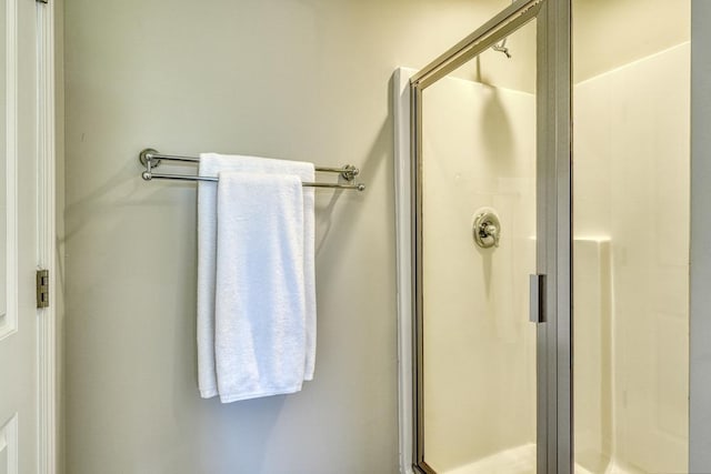 bathroom featuring a shower with shower door