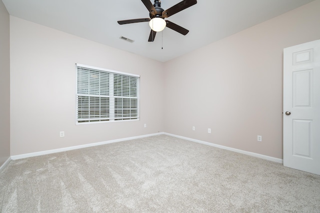 spare room with light carpet and ceiling fan