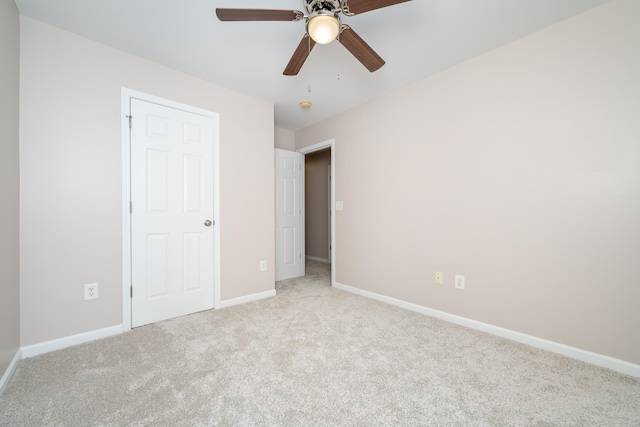 unfurnished bedroom featuring light colored carpet and ceiling fan