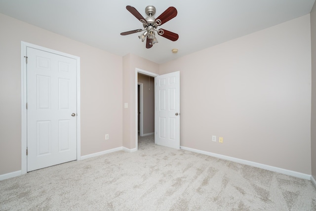 unfurnished bedroom with ceiling fan and light carpet