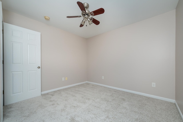 carpeted spare room featuring ceiling fan