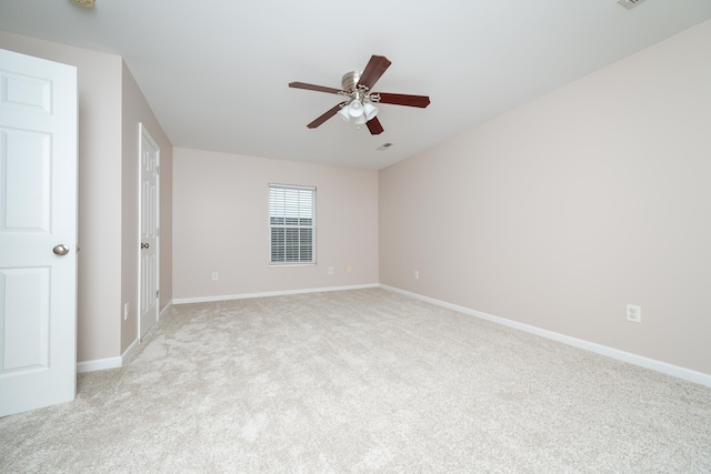 empty room with ceiling fan and light carpet