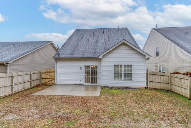 back of house with a patio and a lawn