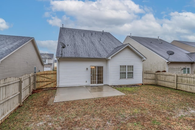 rear view of property with a patio and a lawn