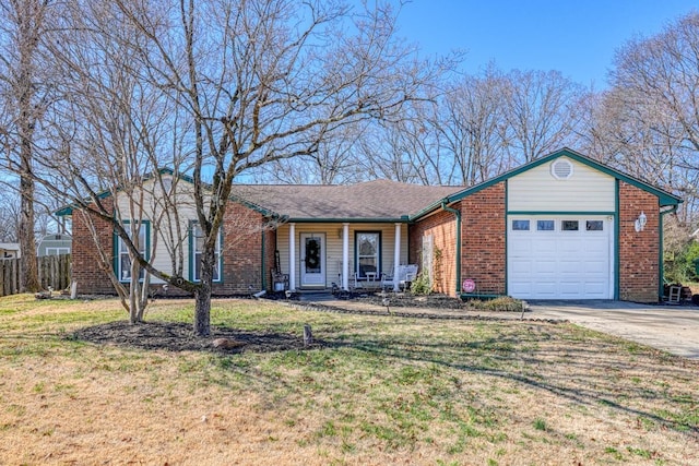 ranch-style home with covered porch, a front yard, and a garage