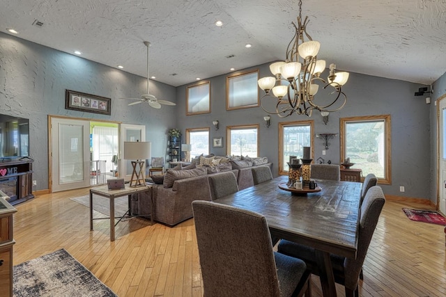 dining area featuring high vaulted ceiling, light hardwood / wood-style flooring, and plenty of natural light