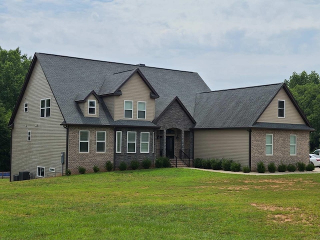 view of front of home featuring central air condition unit and a front lawn