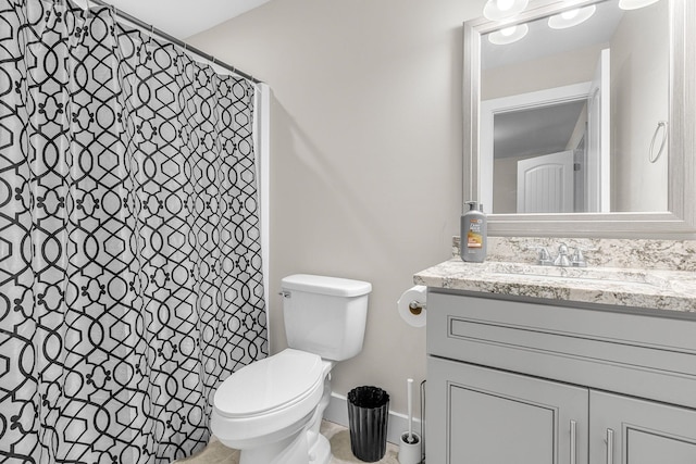 bathroom featuring vanity, a shower with shower curtain, and toilet