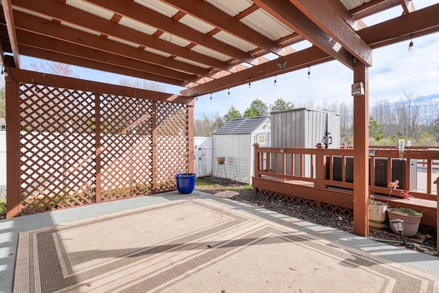 wooden terrace with a shed and a patio area