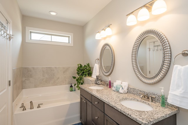 bathroom with vanity and a bath