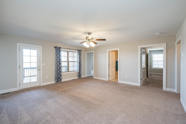 carpeted spare room with ceiling fan