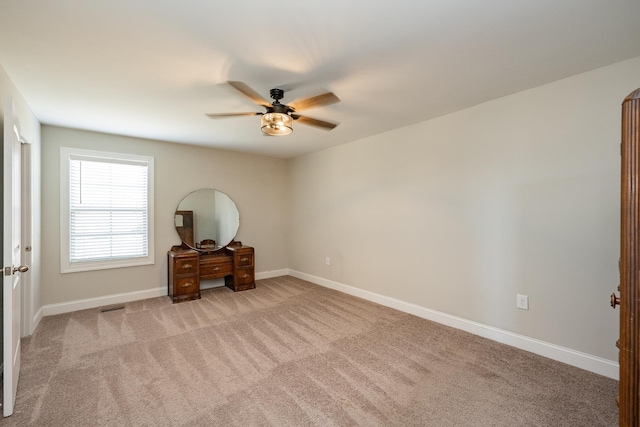 unfurnished bedroom with light carpet and ceiling fan