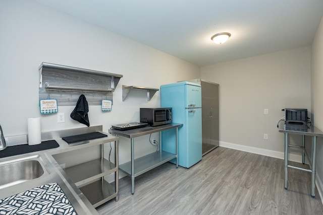 kitchen with fridge and wood-type flooring
