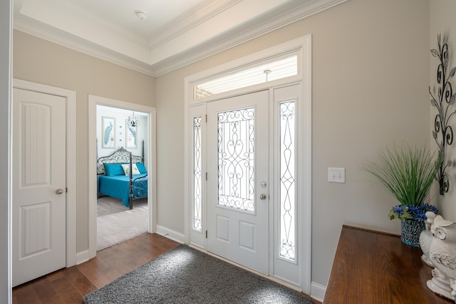 entrance foyer featuring dark hardwood / wood-style flooring, plenty of natural light, and crown molding