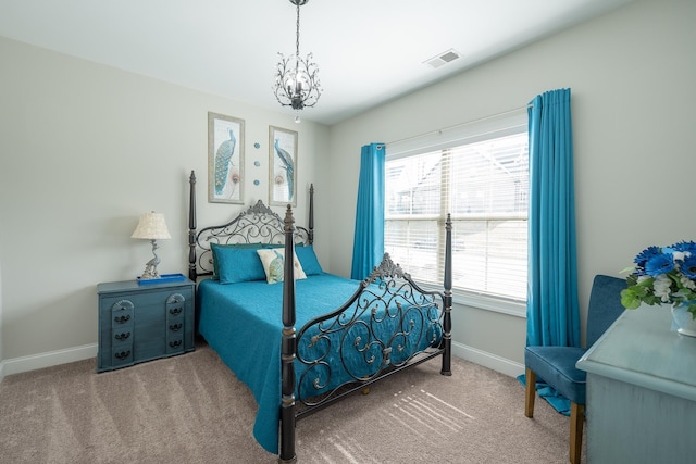 carpeted bedroom with a chandelier