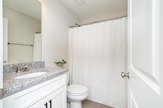 bathroom featuring toilet and vanity