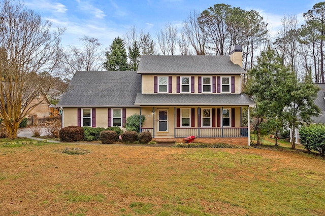 view of front of property with covered porch and a front yard