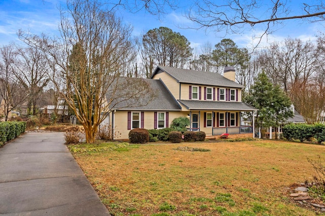 colonial house with a front yard and a porch