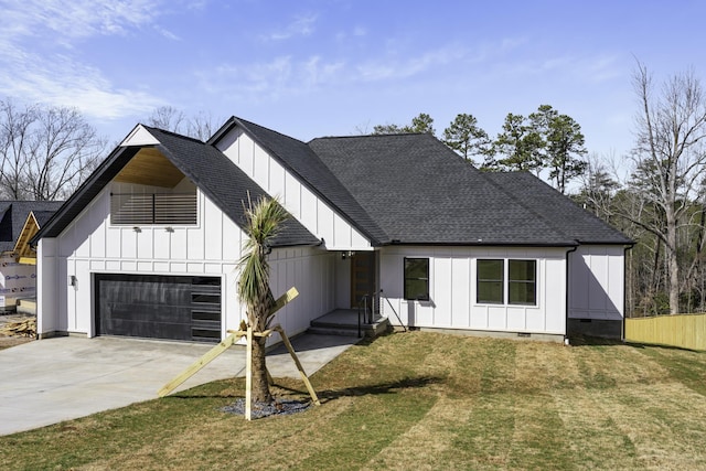 modern farmhouse with a front yard and a garage