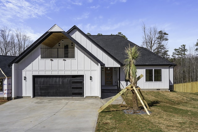 modern farmhouse style home with a front lawn and a garage