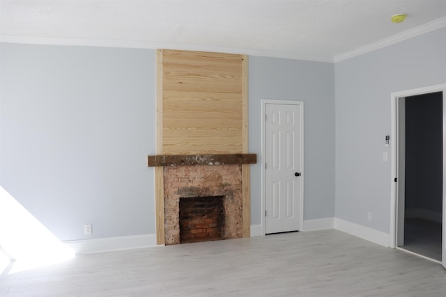 unfurnished living room with hardwood / wood-style floors, crown molding, and a premium fireplace