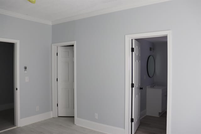 unfurnished bedroom with light wood-type flooring and ornamental molding