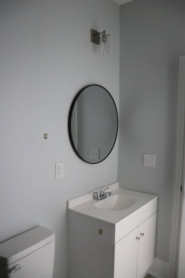bathroom featuring toilet and vanity