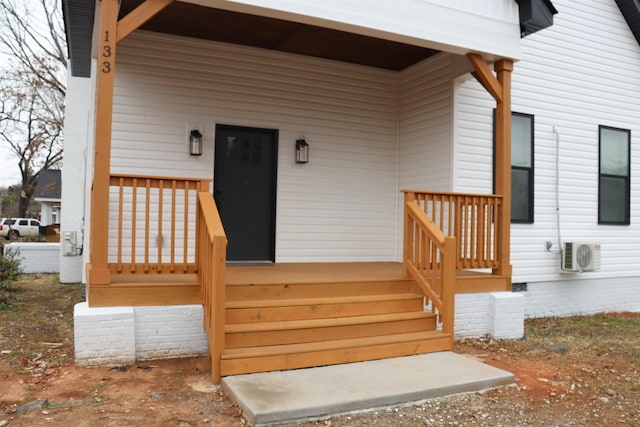 entrance to property with ac unit and a porch