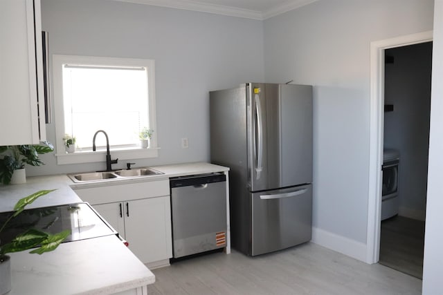 kitchen with stainless steel appliances, white cabinets, light hardwood / wood-style floors, crown molding, and sink