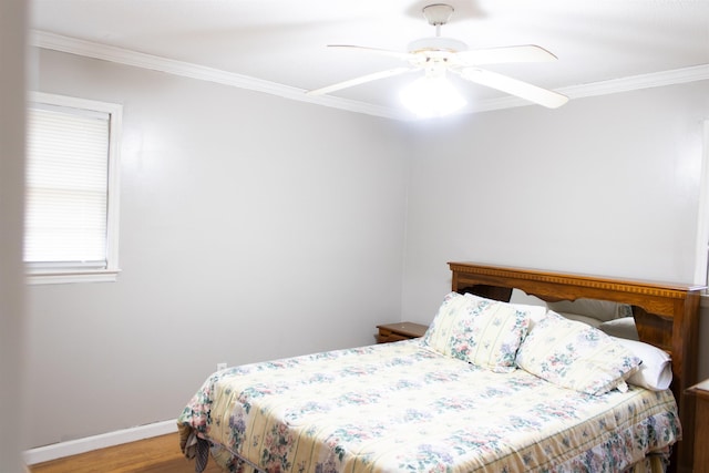 bedroom with crown molding, ceiling fan, and wood-type flooring