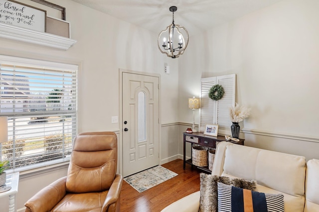 foyer featuring an inviting chandelier and dark hardwood / wood-style floors