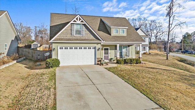 view of front of house featuring a front lawn, a garage, and a porch