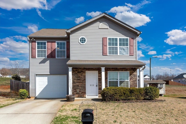 view of property featuring a front lawn and a garage