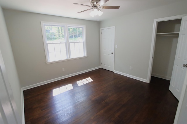 unfurnished bedroom with dark wood-style flooring, baseboards, and ceiling fan