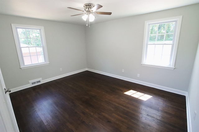 spare room featuring baseboards, visible vents, and a wealth of natural light