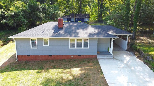 ranch-style house with a shingled roof, crawl space, a chimney, concrete driveway, and a front lawn