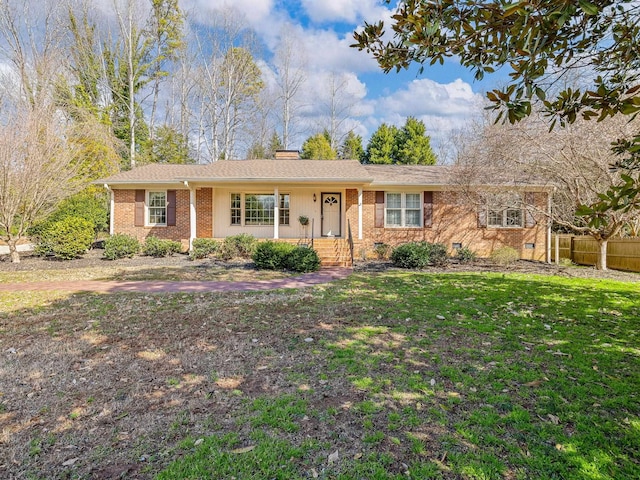 single story home featuring a chimney, brick siding, crawl space, and a front yard