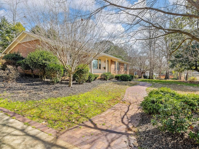 exterior space featuring brick siding and stucco siding